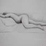 A nude model lying on her stomach. Pencil drawing