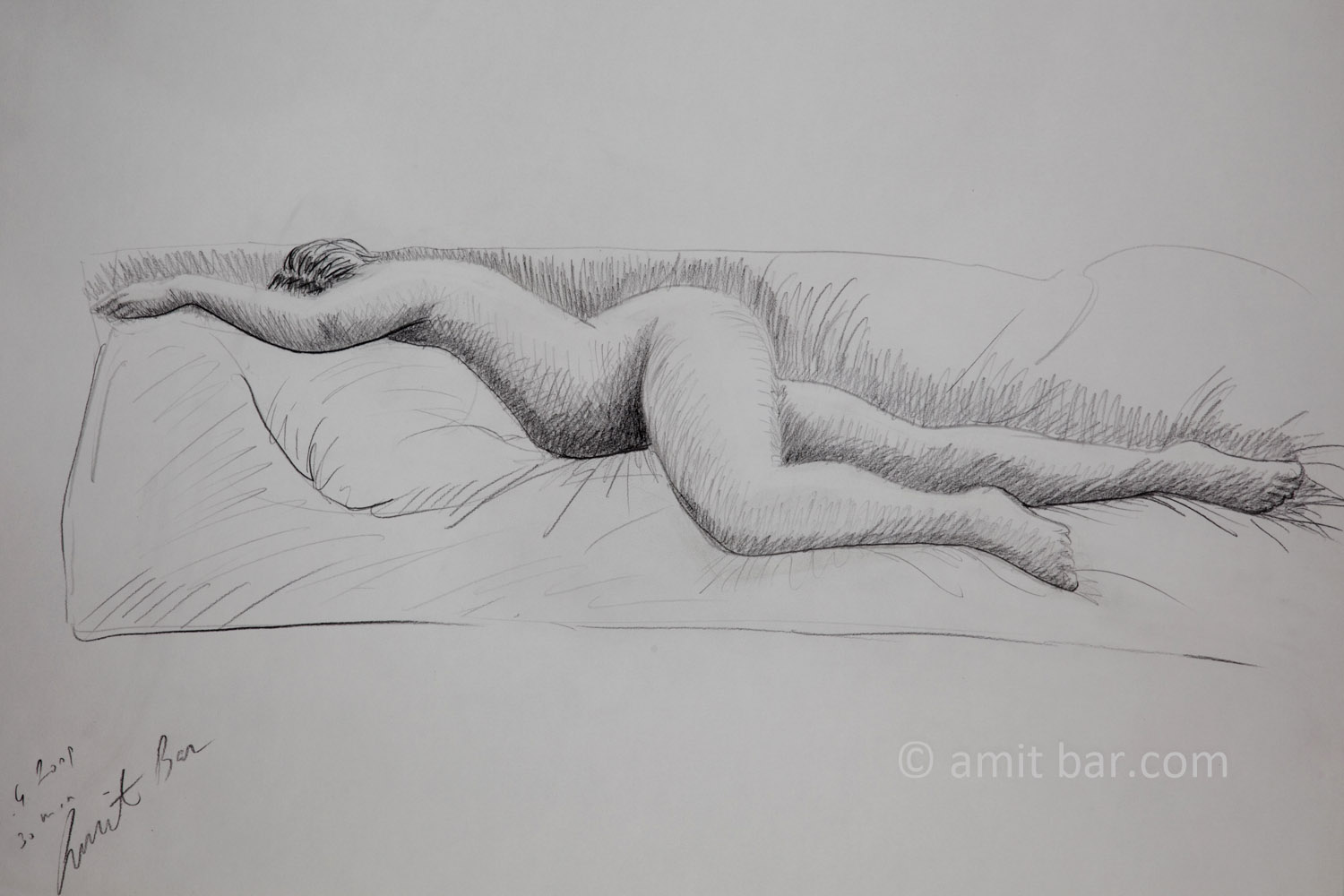 A nude model lying on her stomach. Pencil drawing