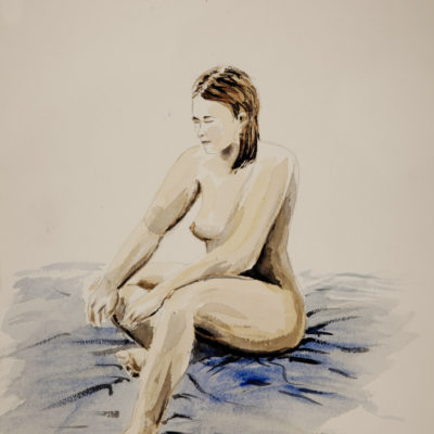 A nude model sitting on the floor