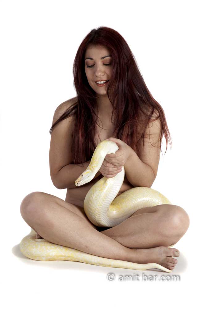Albino python III: Nude model holds albino python