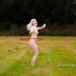 Ankie hula hooping II: Model Ankie is exercising hula hooping in nature