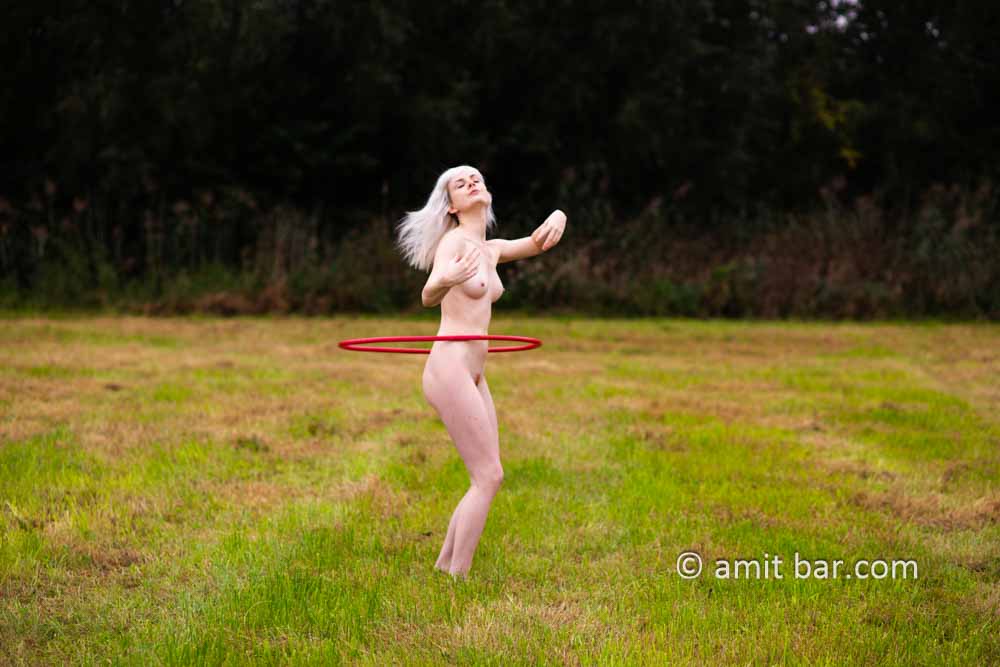 Ankie hula hooping II: Model Ankie is exercising hula hooping in nature