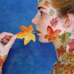 Autumn leaves body-painting IV: Portrait of a body-painted model with autumn leaves