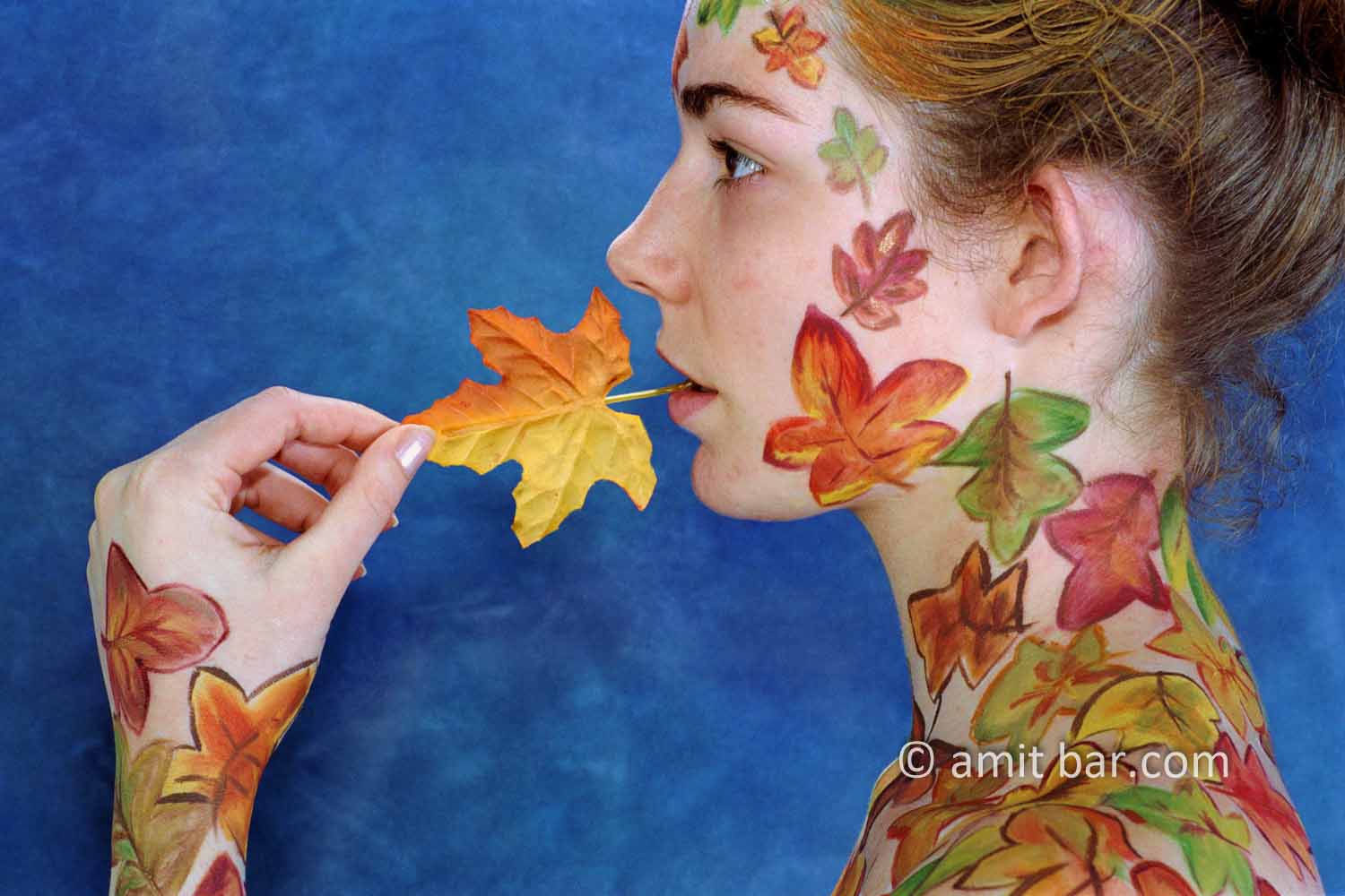 Autumn leaves body-painting IV: Portrait of a body-painted model with autumn leaves