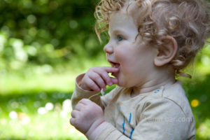 Baby with a flower: Baby holds a flower