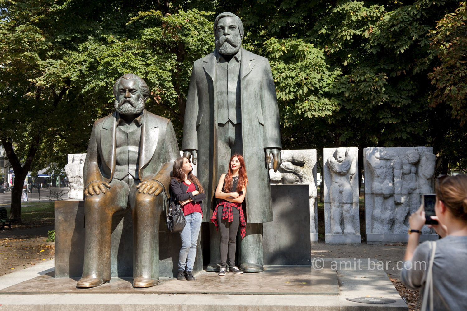 Berlin 2: The influence of Marx and Engels. Two girls beside the sculptures of Marx and Engels