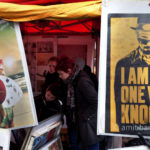 Berlin: I am the one. A boy is searching video film on the Sunday market.