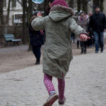 Berlin: Soap bubble. A girl is chasing a soap bubble