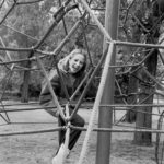 Big laugh: A girl is laughing on climbing-instrument