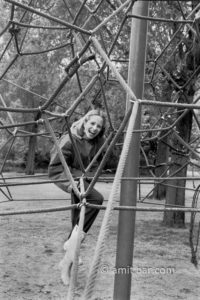 Big laugh: A girl is laughing on climbing-instrument