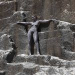 Black rock 2-II: Body-painted model is standing in a ancient quarry