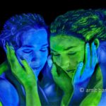 Blue and green I: Two body-painted models in UV blue and green