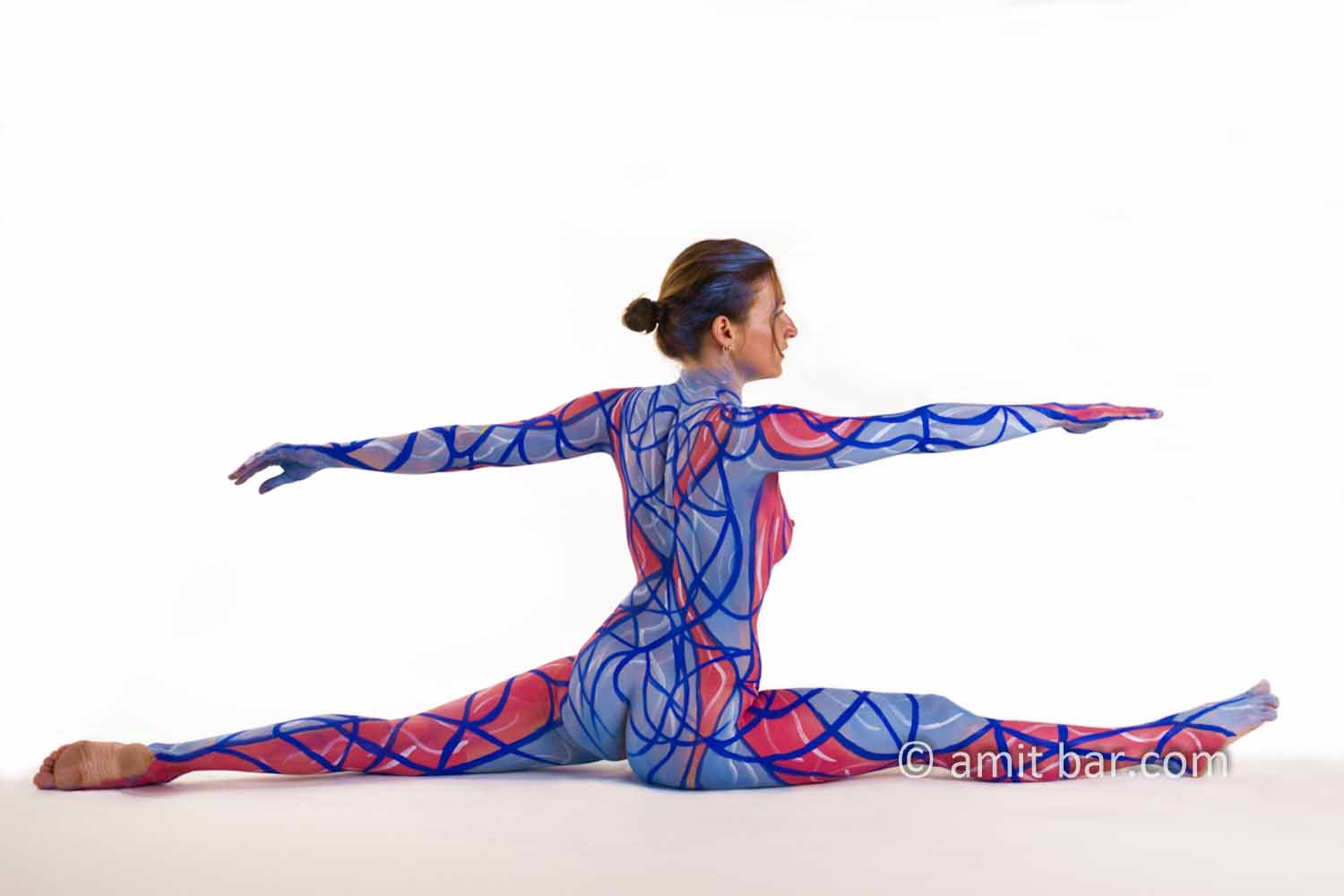 Blue and Red II: Body-painted yoga model in blue and red