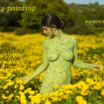 Brida body-painting: Body-painted model Brida is walking among the wild Chrysanthemum flowers on mount Carmel