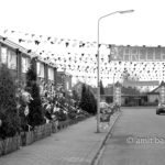Burying a feast: A man is digging in his garden, while the street is empty after the feast