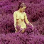 Calluna vulgaris I: Body-painted model with common heather flowers in the nature