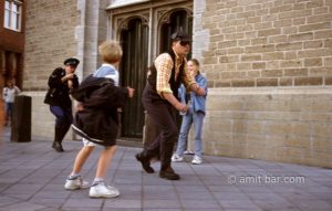 Catch the thief!: Two actors dressed as a thief and policeman are chasing each other at street theater festival in Doetinchem, The Netherlands