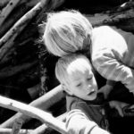 Climbing together: Two boys playing