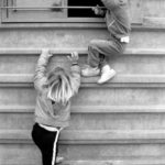 Climbing upwards: Two boys are climbing on a store wall