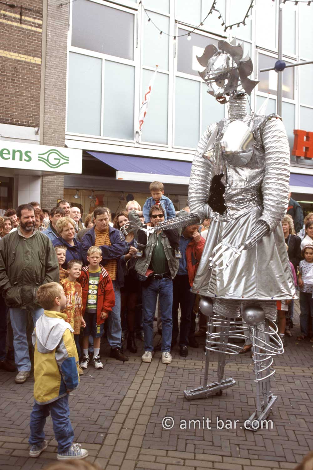David and Goliath: A child is watching a huge robot on Street theater festival in Doetinchem, The Netherlands