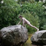 Dolmen woman body-painting IV: body painted Elle is walking and laying around and on the huge stones of the dolmen at Drenthe, The Netherlands