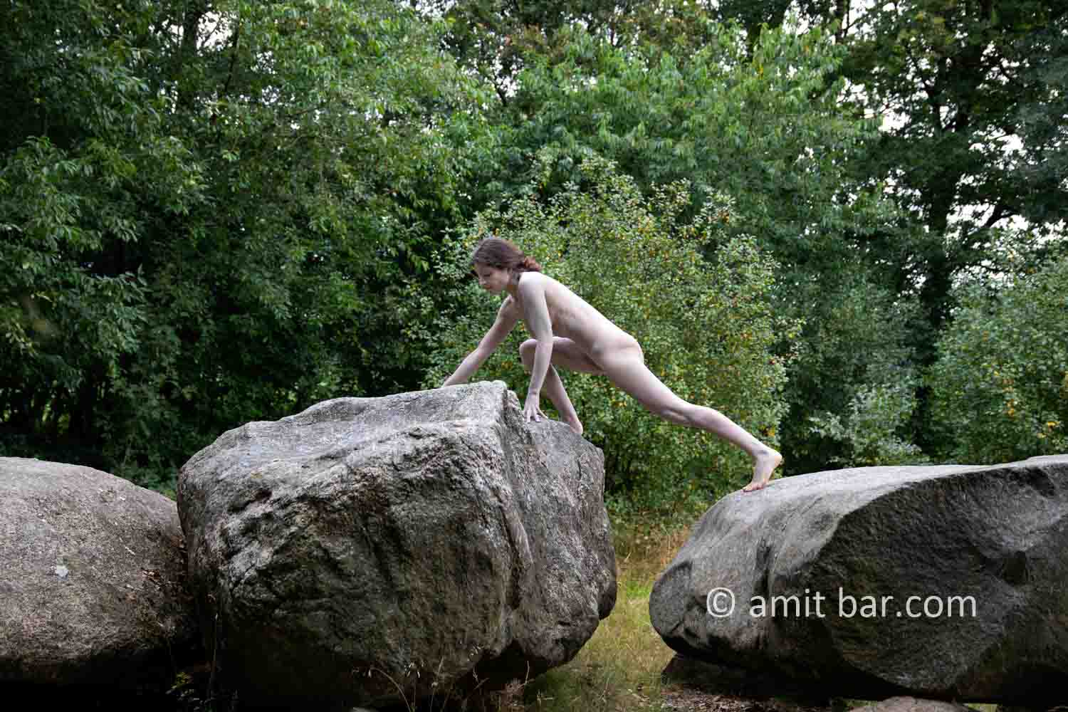 Dolmen woman body-painting IV: body painted Elle is walking and laying around and on the huge stones of the dolmen at Drenthe, The Netherlands