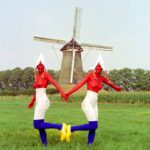 Double Dutch I: Two body-painted models as Dutch flag with a windmill in the background