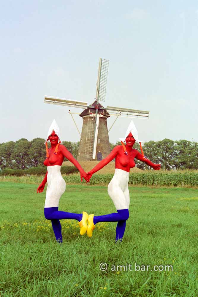 Double Dutch I: Two body-painted models as Dutch flag with a windmill in the background