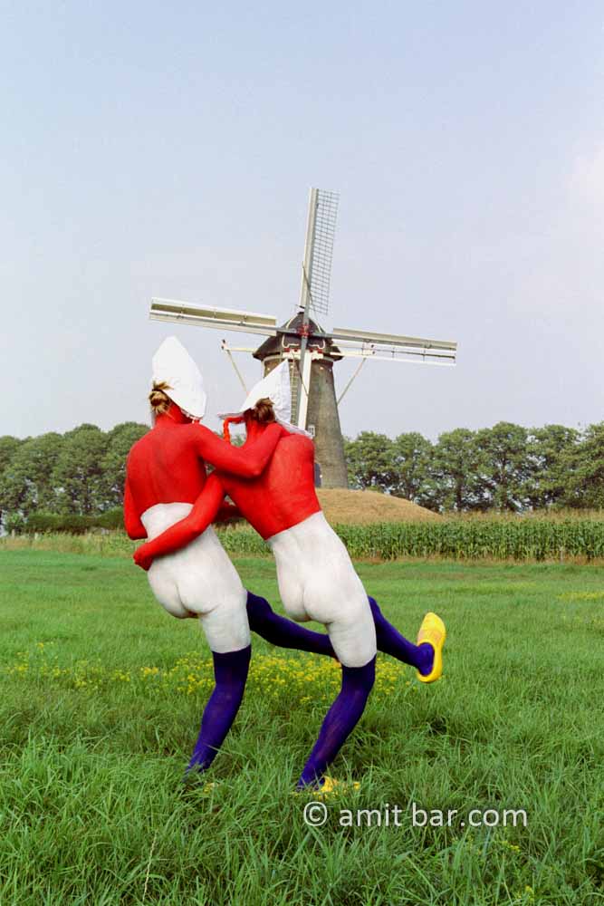 Double Dutch II: Two body-painted models as Dutch flag with a windmill in the background