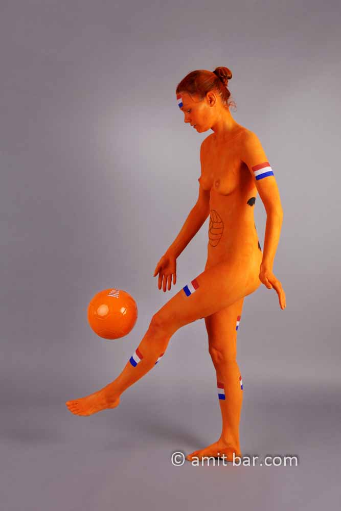 Dutch soccer I: Body-painted model in orange and a football