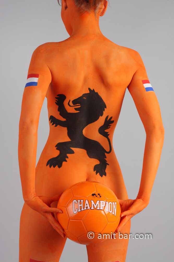 Dutch soccer II: Body-painted model in orange, black lion and a football