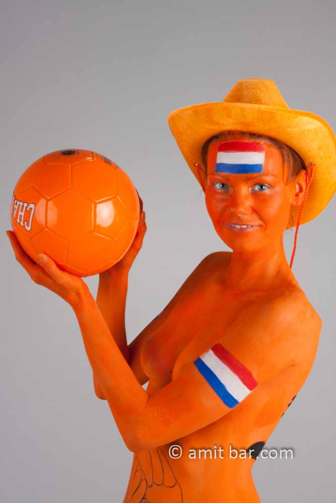 Dutch soccer III: Body-painted model in orange and a football