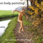 Ella autumn body-painting: Body-painted Ella is dancing among the autumn leaves in nature