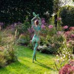 Garden flowers I: A body painted model is walking on a cloudy afternoon among the flowers of a beautiful garden in De Achterhoek, The Netherlands.