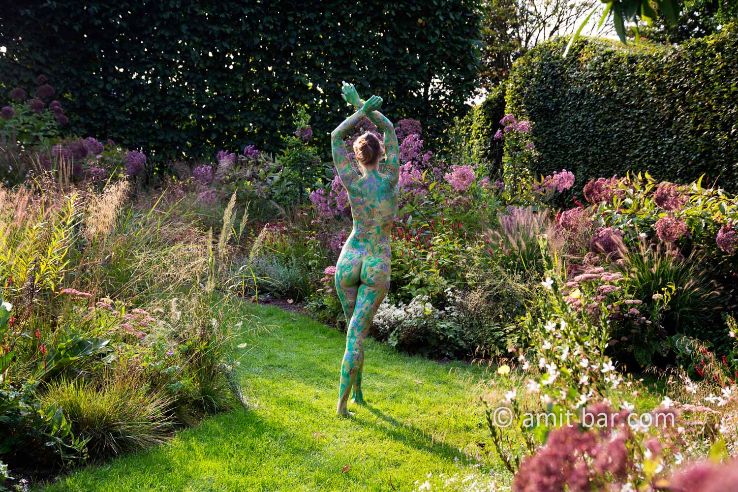 Garden flowers I: A body painted model is walking on a cloudy afternoon among the flowers of a beautiful garden in De Achterhoek, The Netherlands.