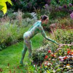 Garden flowers II: A body painted model is walking on a cloudy afternoon among the flowers of a beautiful garden in De Achterhoek, The Netherlands.