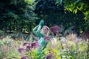 Garden flowers portrait: Portrait of a body painted model among garden flowers