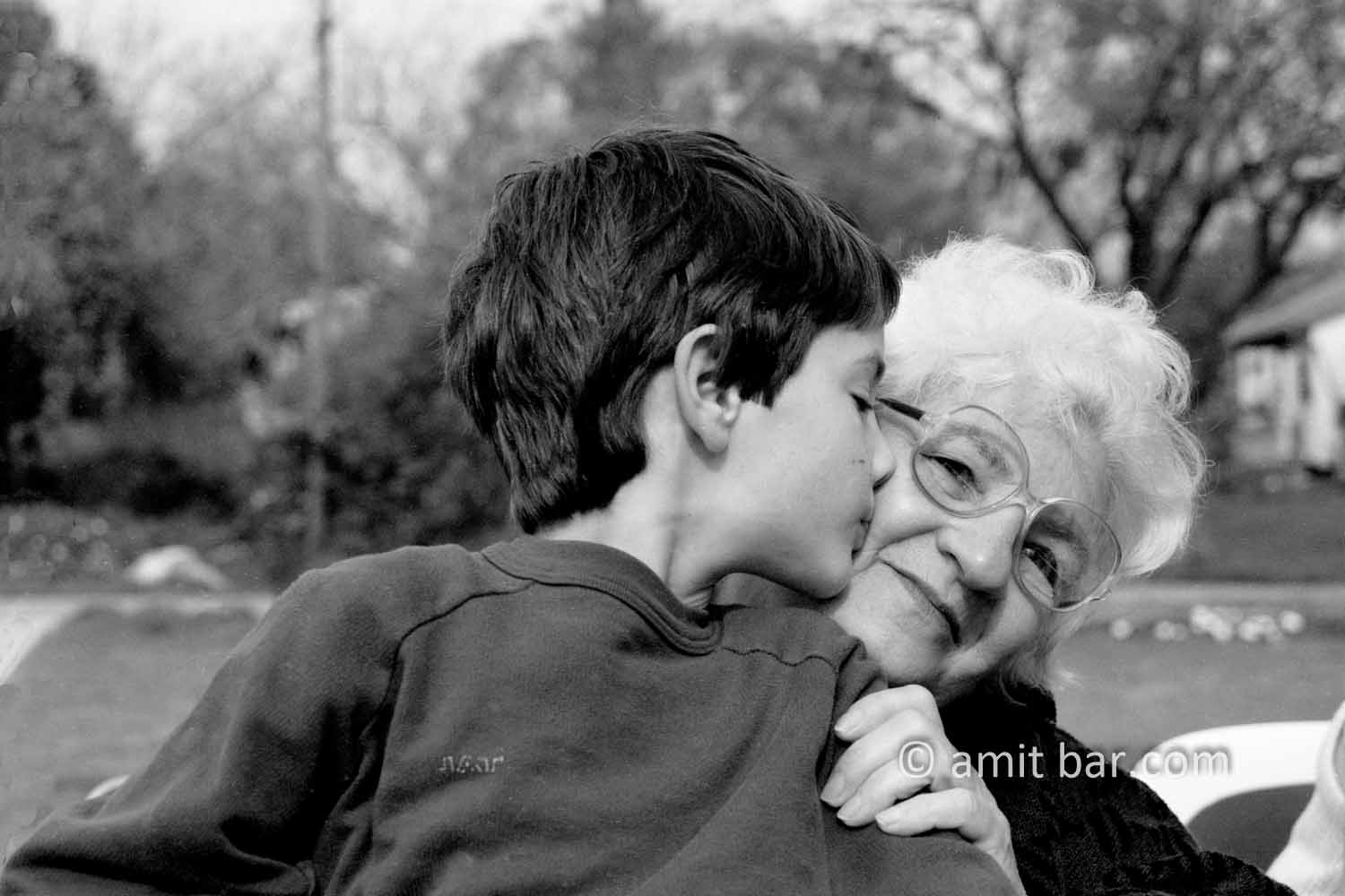 Grandmother and her grandson II: A gandmother is been kissed by her grandson