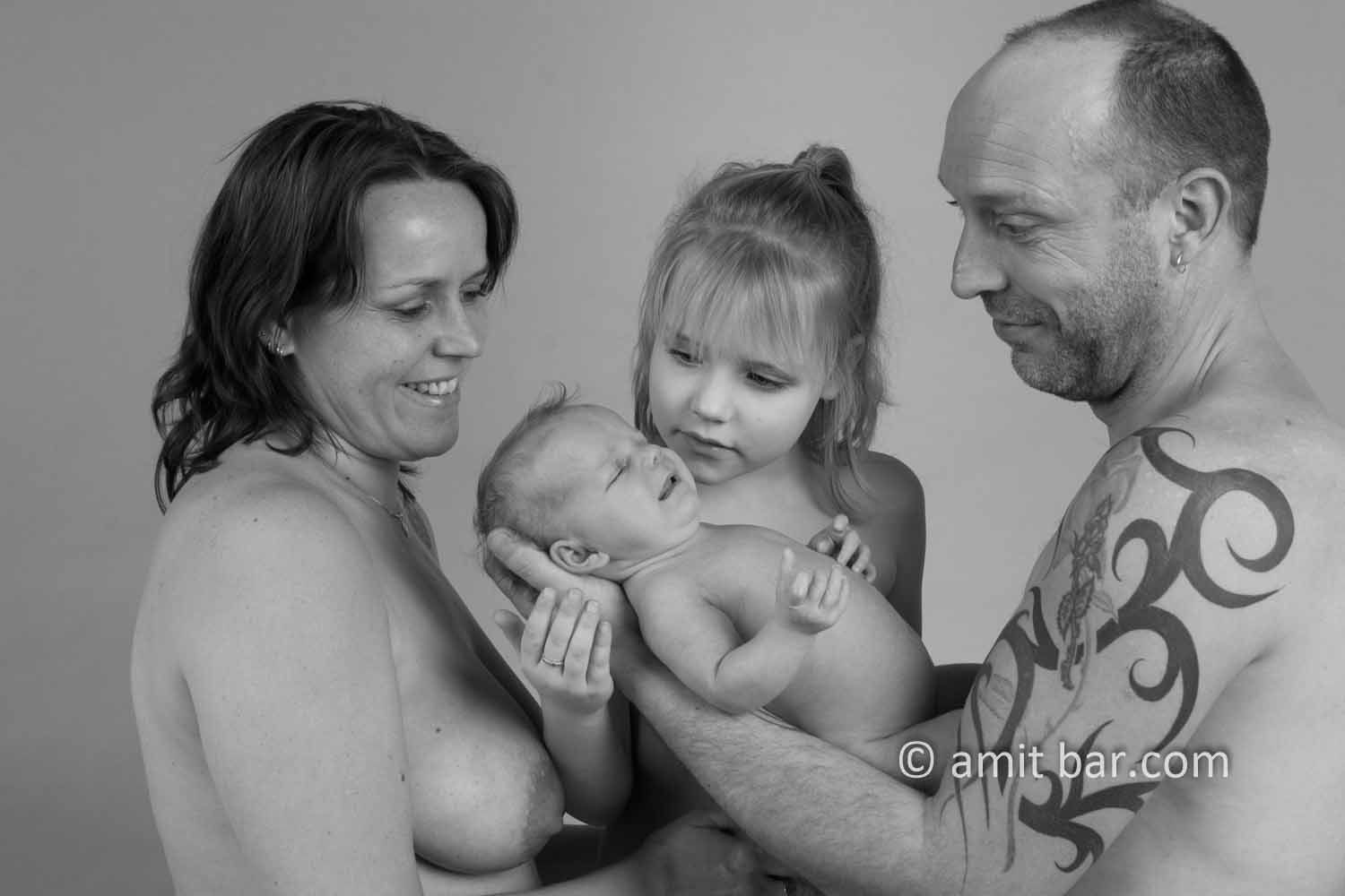 Happy family portrait I: Father, mother, daughter and baby