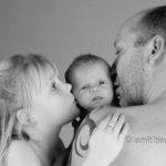 Happy family portrait II: Father, daughter and baby