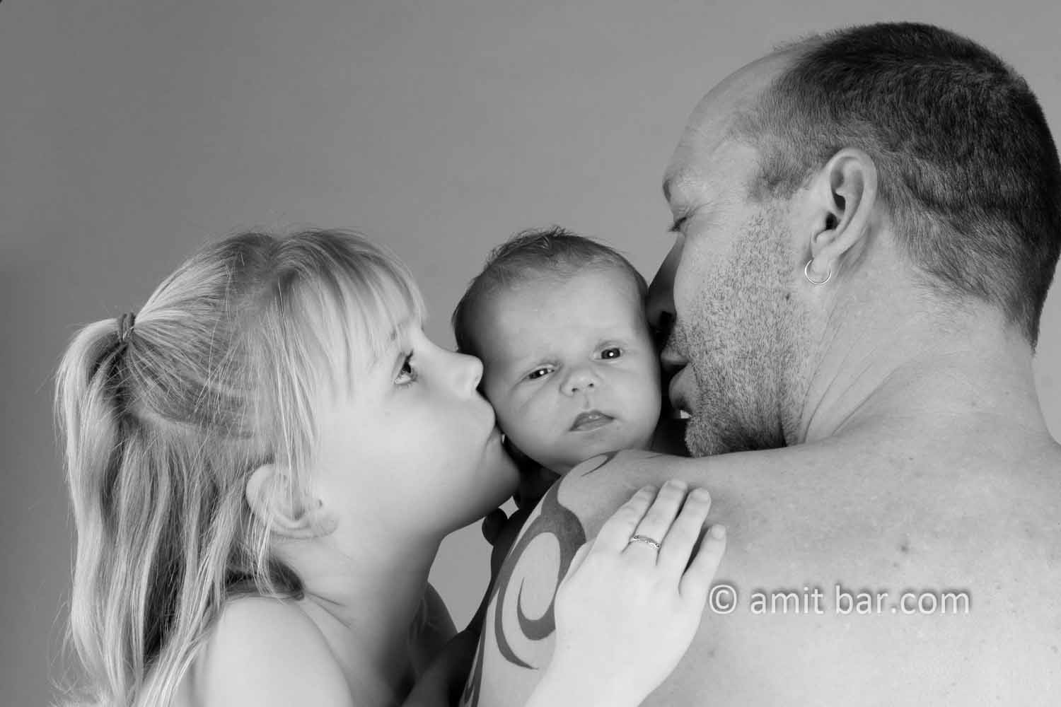 Happy family portrait II: Father, daughter and baby