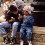 Let me help you: Two children are likking ice-cream