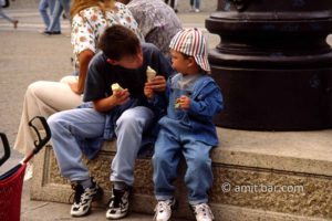 Let me help you: Two children are likking ice-cream