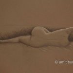 Lying nude model from her back on brwon paper. Pencil drawing