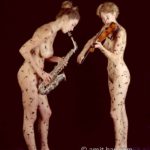 Music notes I: Two body-painted models playing horn and flute