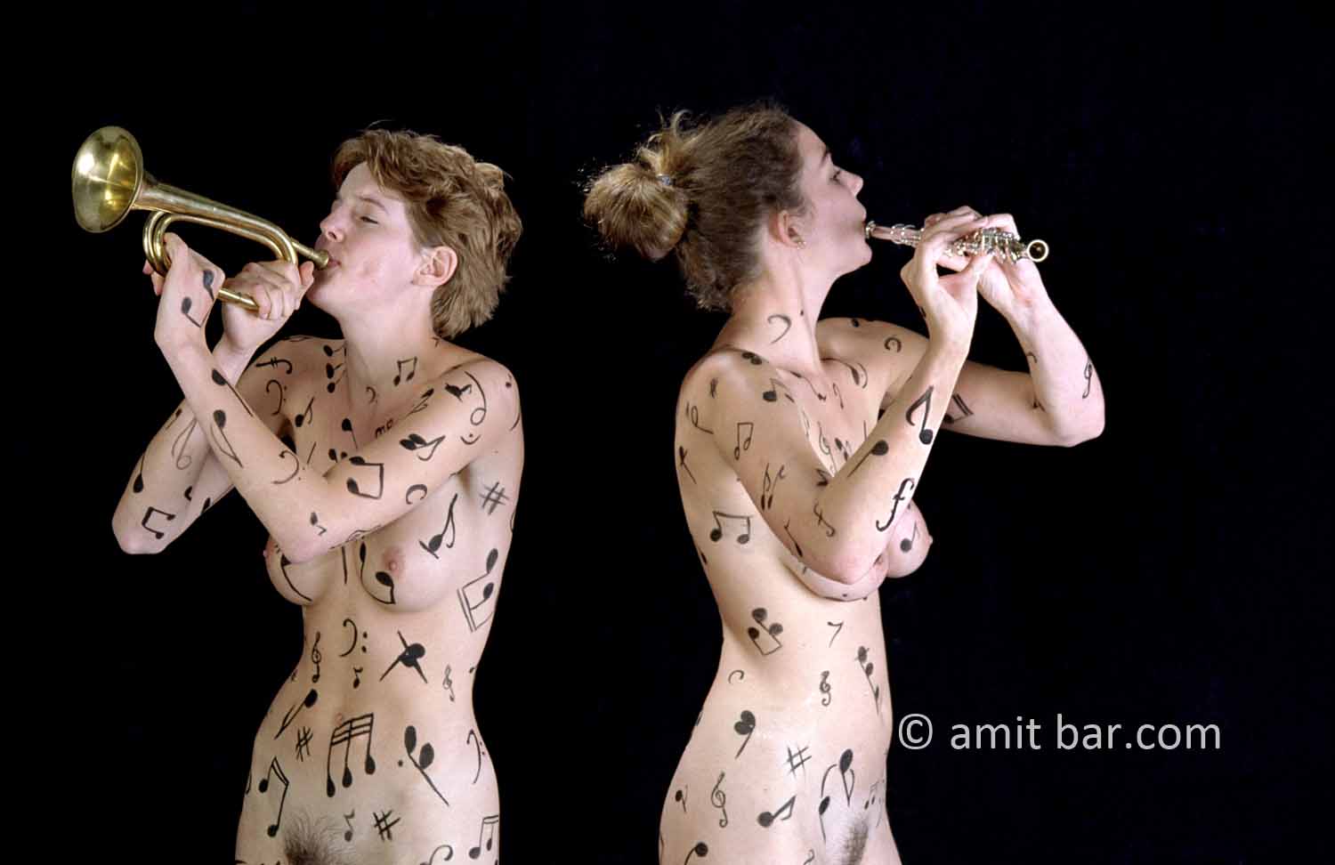 Music notes III: Two body-painted models playing horn and flute