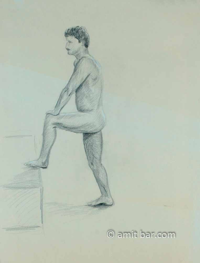 Nude man with leg on box. Pencil drawing