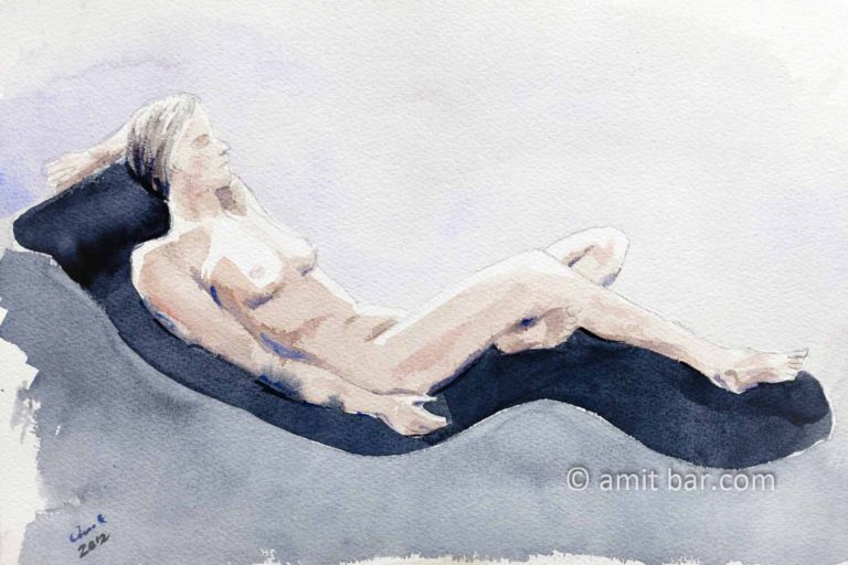 Nude model laying on a relaxing chair