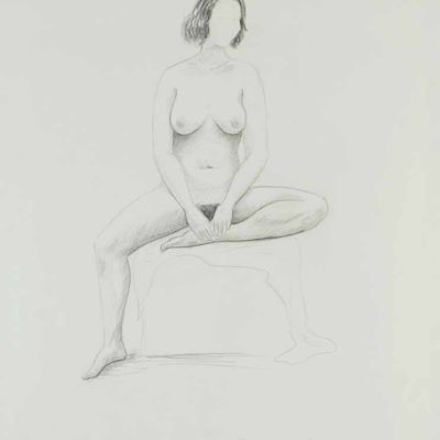 Nude woman sitting on a low box