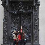Paris: Look at THEM!: Paris snapshot: a group of three girls pointing to the sculpture of Rodin The gates of hell.